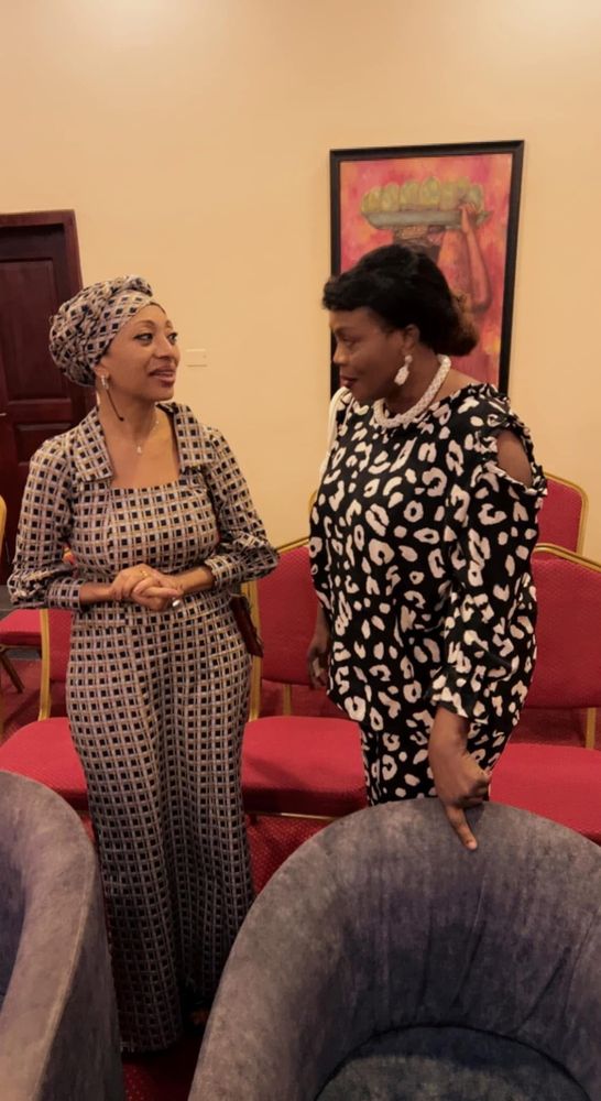 Two women in conversation at a reception