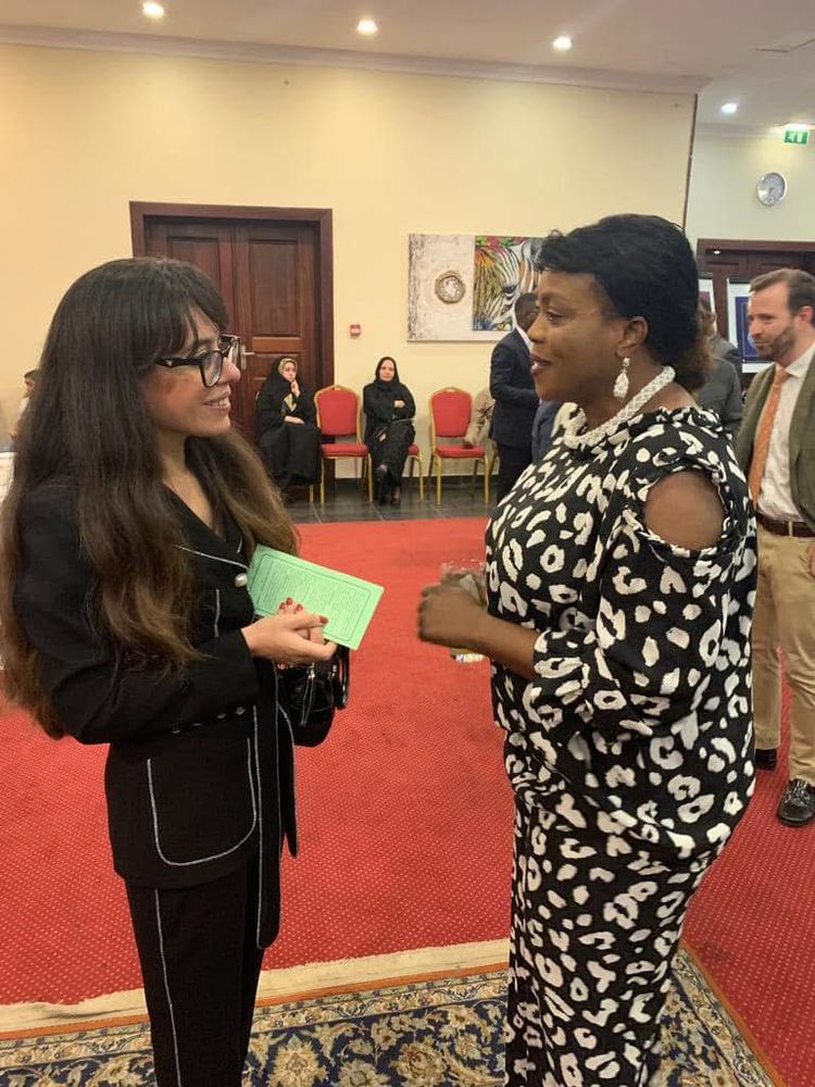 Two women in conversation at a reception