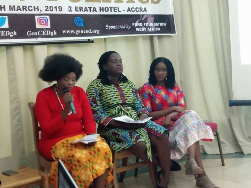 Three women seated on a discussion panel