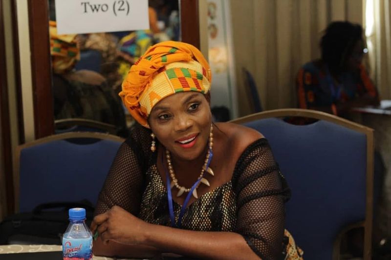 A woman in a headwrap at a workshop
