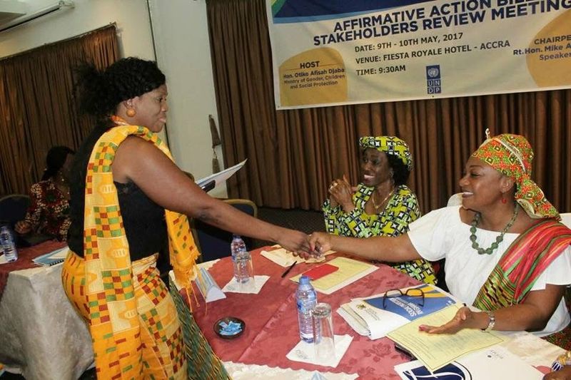 Participants greeting each other at a stakeholders' meeting