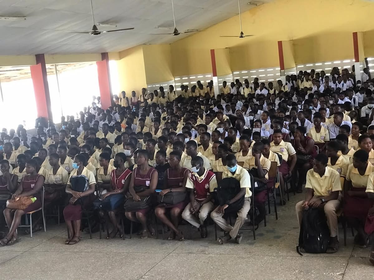 Secondary school students gathered in an assembly hall
